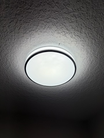 Ceiling light fixture installed on a textured ceiling in a Calgary home by Calgary Repairs