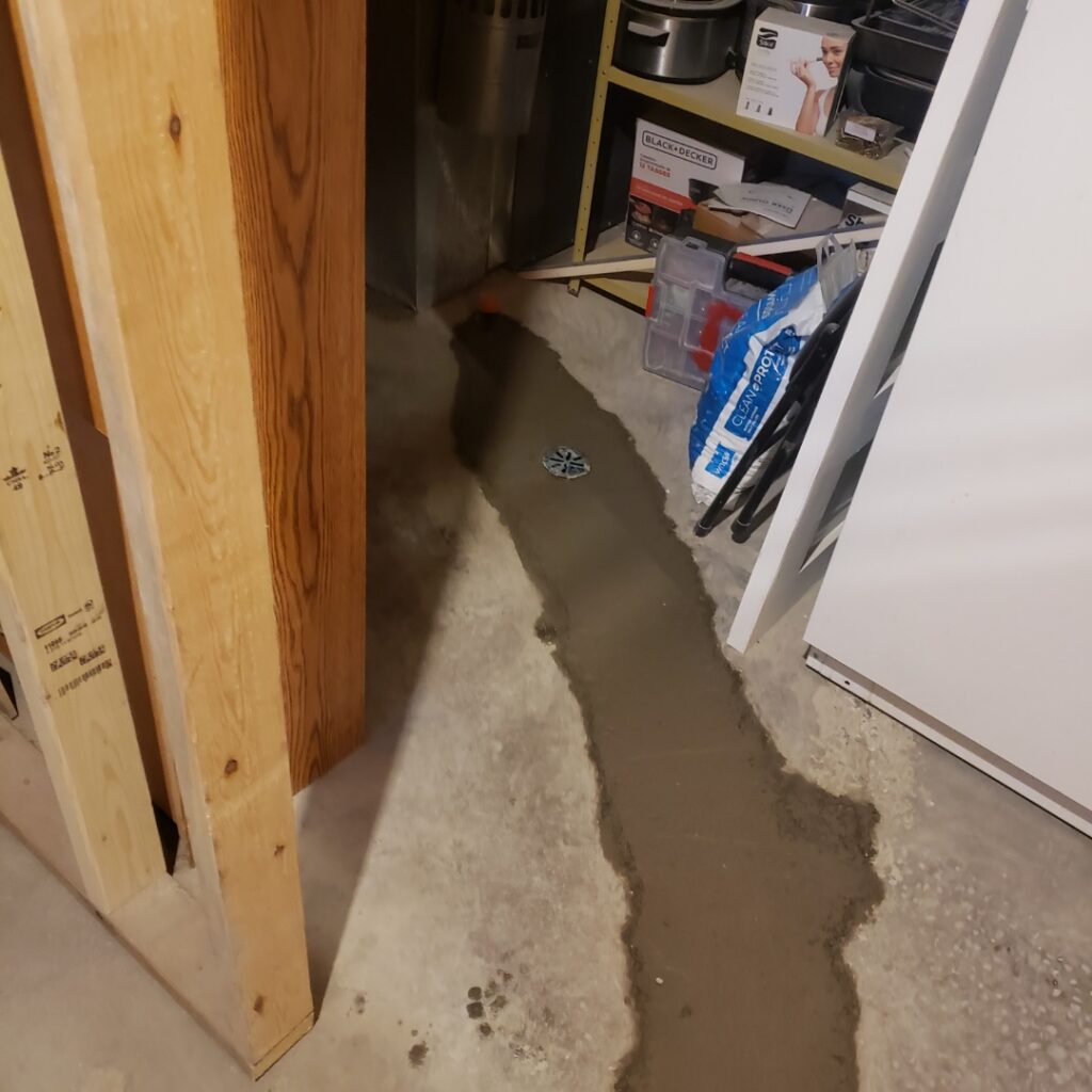 Basement floor drain set in fresh concrete in a Calgary home by Calgary Repairs