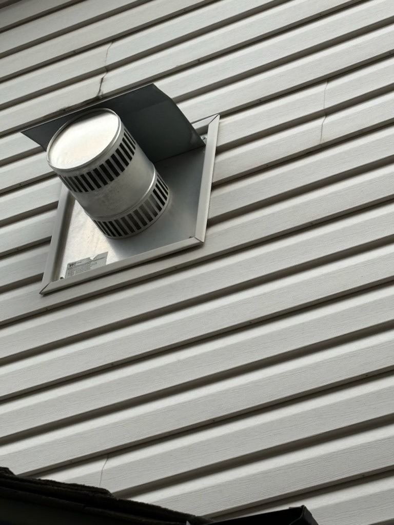 Exterior vent on house siding by Calgary Repairs