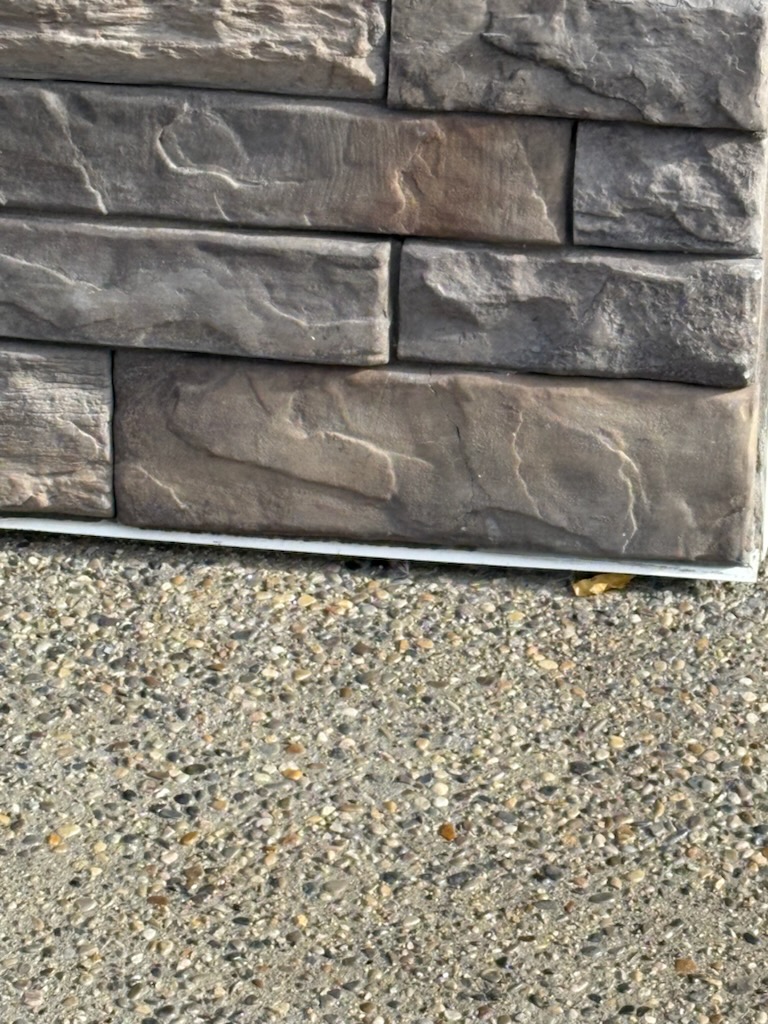Stone veneer wall repair on a Calgary home by Calgary Repairs